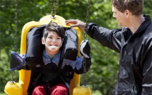 a person and a boy in a swing
