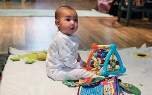 a baby sitting on the floor