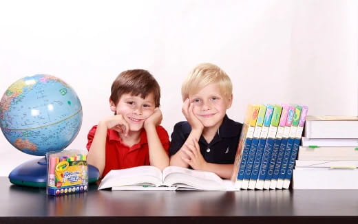 two boys sitting at a table