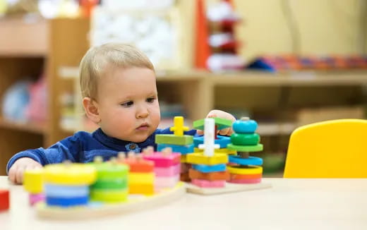 a baby playing with toys