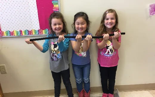 a group of girls holding a toy sword