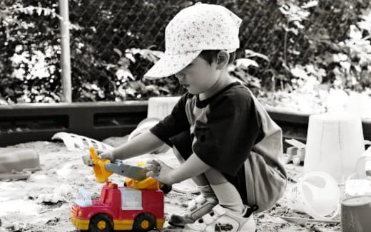 a child playing with a toy truck