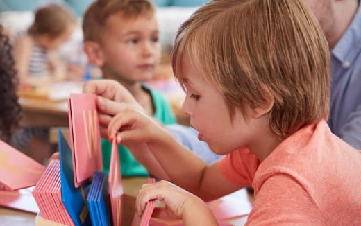 a young girl coloring on paper