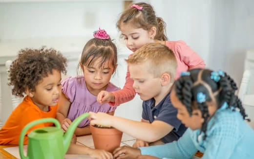 a group of children playing with a cup