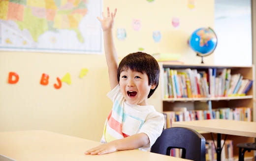 a child raising his hand