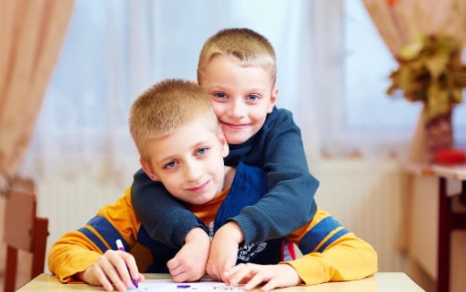 two boys sitting at a table