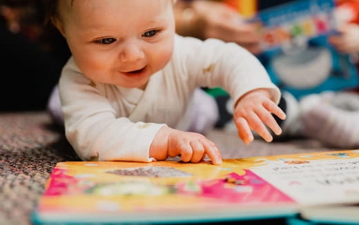 a baby looking at a book