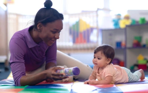 a person and a child playing with a toy