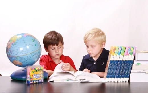 a couple of boys reading books