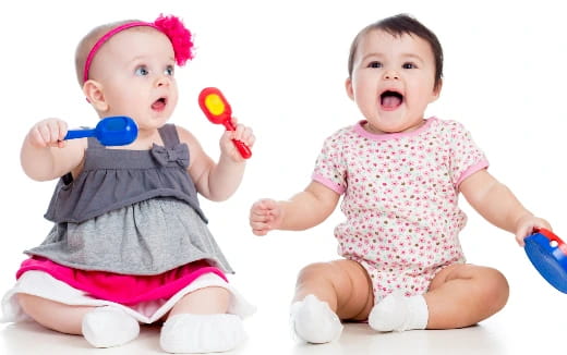 two babies holding toys