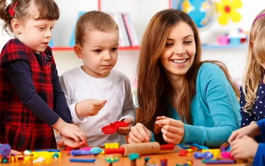 a person and several children playing with toys