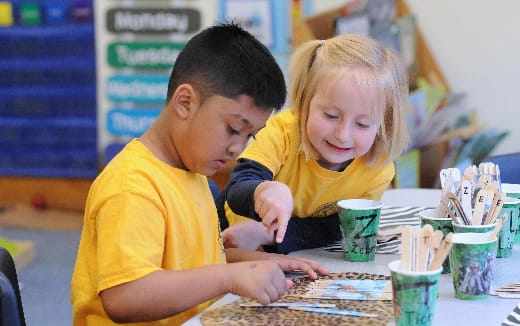 a boy and girl looking at a map