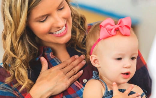 a woman holding a baby