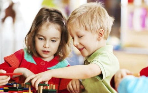 a boy and girl looking at a book