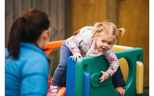 a person and a child sitting in a chair