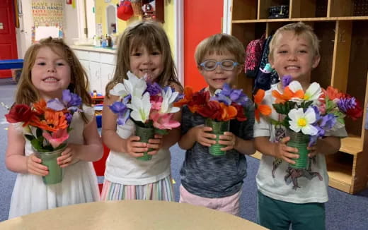 a group of children holding flowers