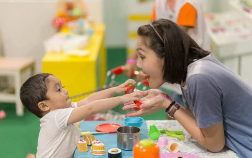 a person and a child playing with toys