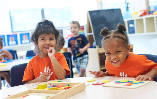 a few children sitting at a table