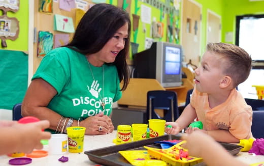 a person and a child playing with toys