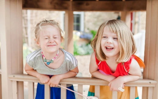 a couple of children sitting at a table