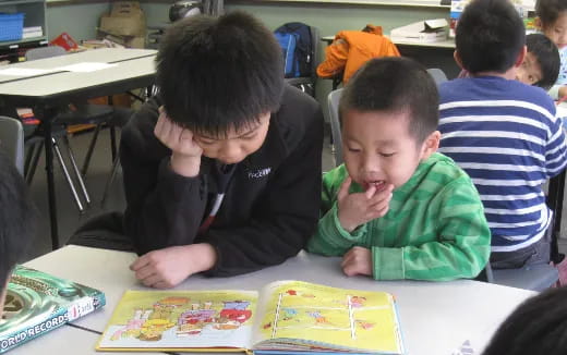 a few children sitting at a table