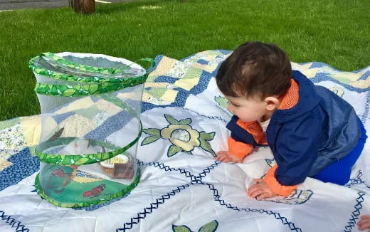 a baby lying on a blanket