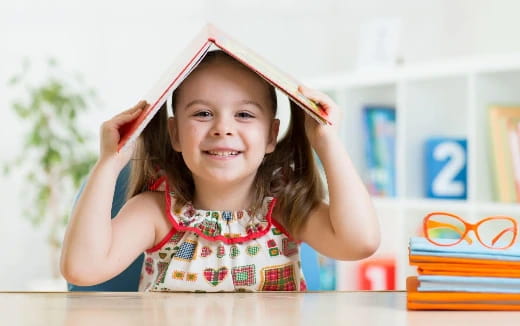 a girl wearing a paper hat