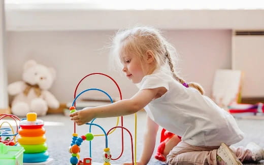 a little girl playing with a toy