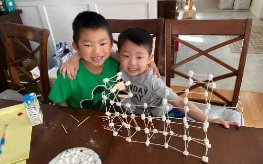 two boys sitting at a table