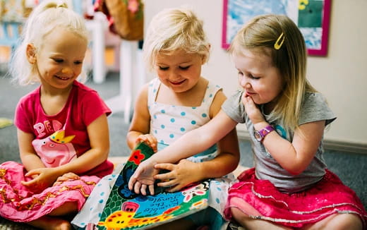 a few young girls playing with a toy