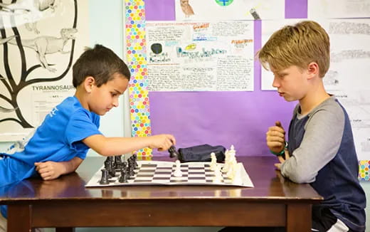 a couple of boys playing chess