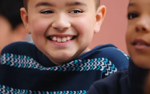 a close-up of a boy smiling