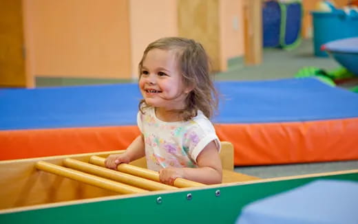 a little girl playing on a playground