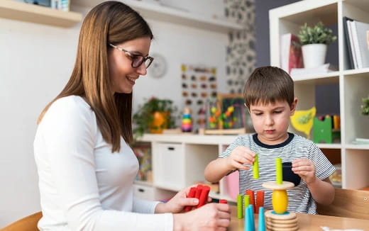 a person and a boy playing with toys