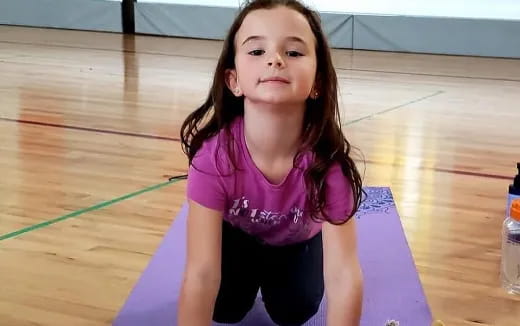 a girl sitting on a mat