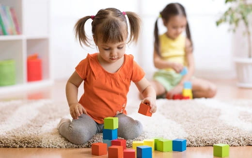 a couple of children playing with toys