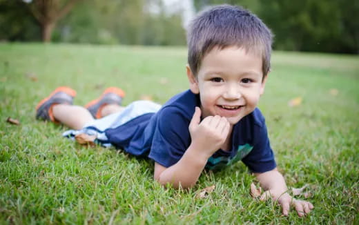 a boy lying on the grass