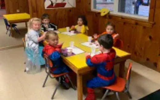 a group of children sitting at a table