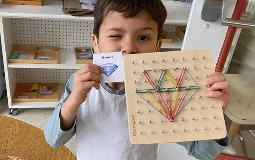 a boy holding a board game