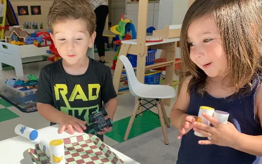 a boy and girl playing with toys