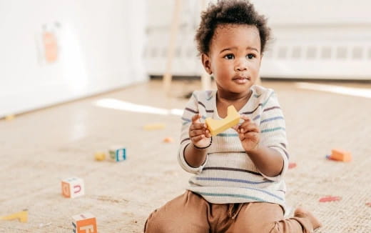 a baby sitting on the floor