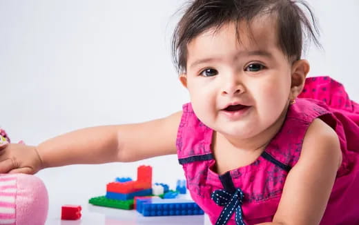 a baby girl playing with toys