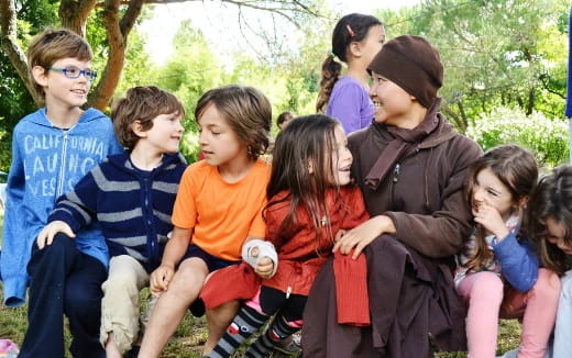 a group of children sitting on a bench