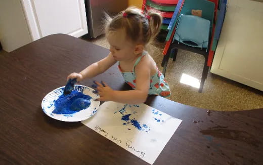 a little girl eating cake