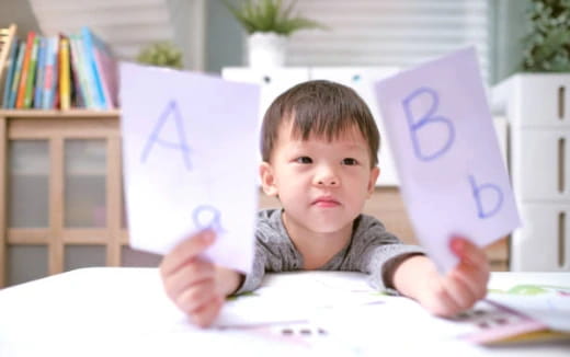 a boy holding a book