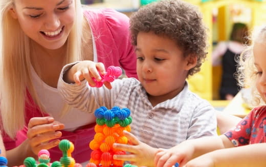 a person and a child playing with toys