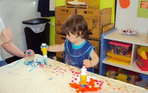 a child sitting at a table