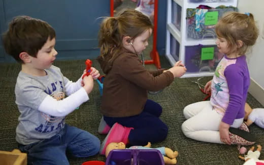 a group of children playing with toys