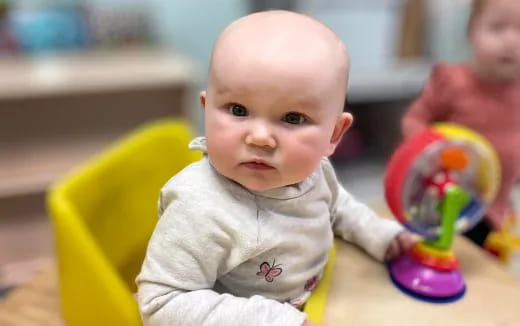 a baby sitting at a table