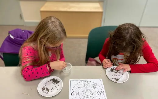 a couple of girls eating at a table